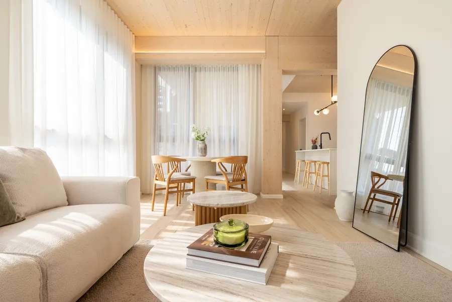 Living room looking toward the kitchen, with wood beams