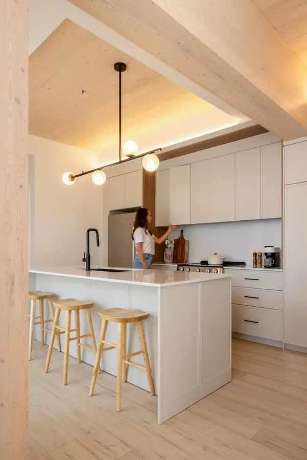 Kitchen island with stools under the wood ceiling