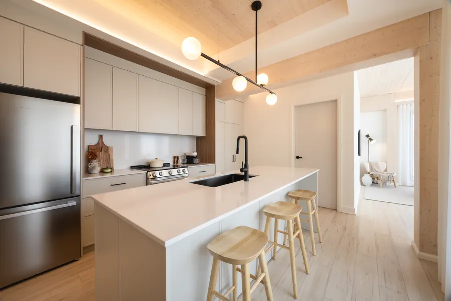Kitchen with quartz counters and lacquered shaker cabinets