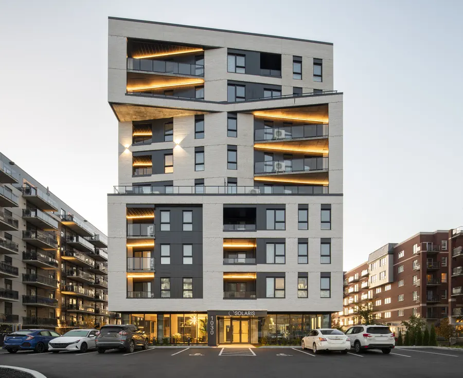 Solaris at dusk, nine storeys with lit balconies