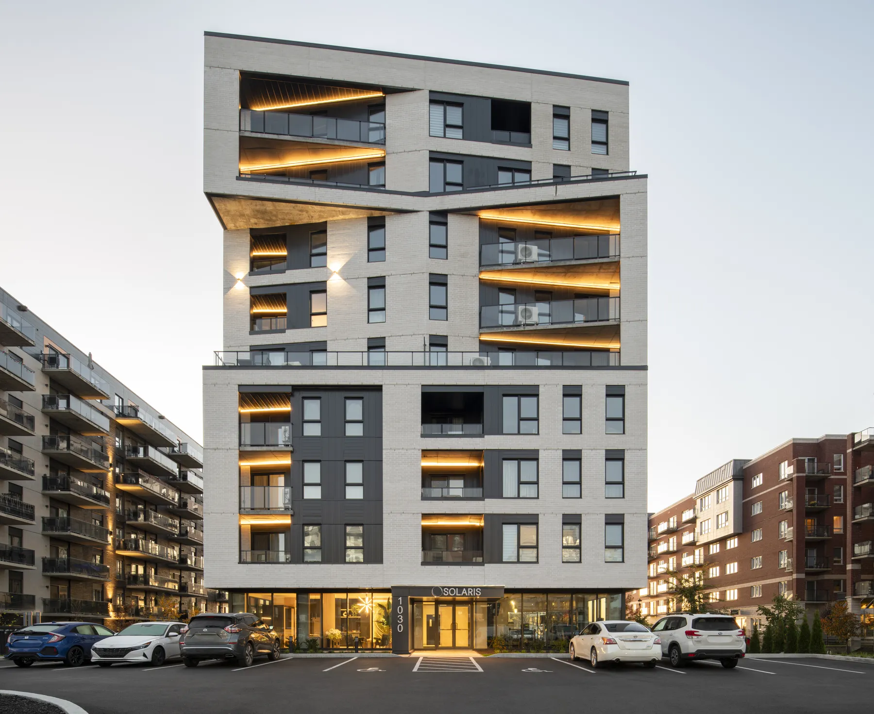 Solaris, a nine-storey rental building in Boisbriand, at dusk