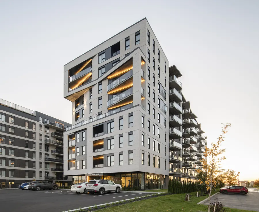 Solaris, a nine-storey rental building in Boisbriand, at dusk