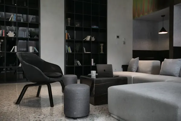 Library corner with lounge chairs and black shelving
